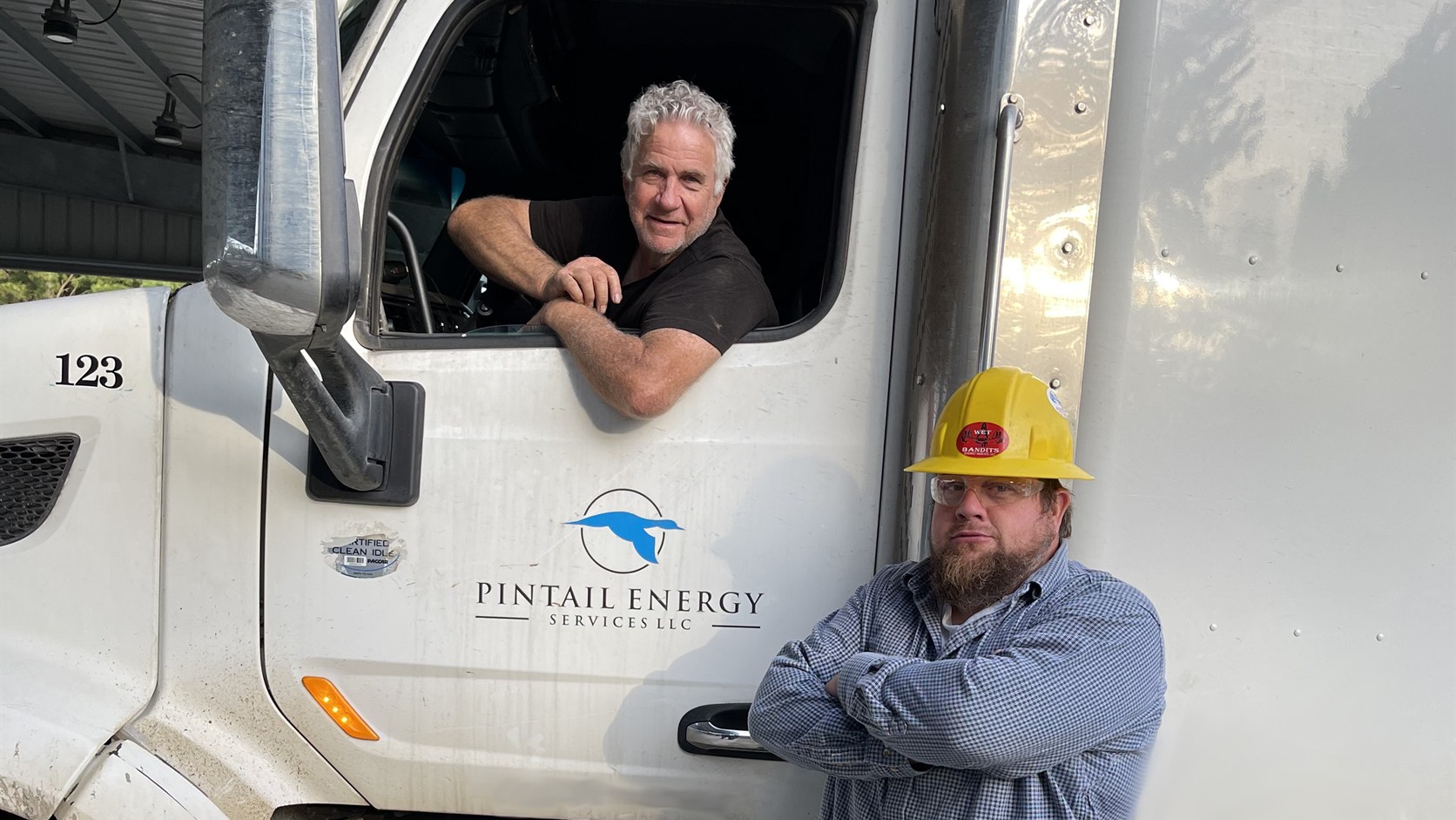 Oilfield drivers with a Pintail Energy truck cab